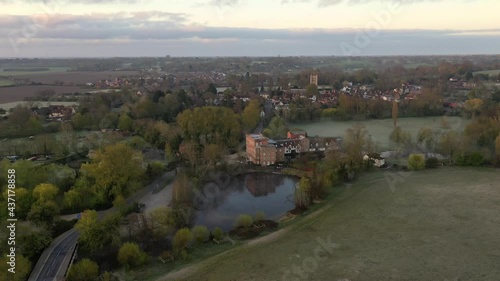 An aerial flight over Dedham Mill towards Dedham village at sunrise with low mist. photo