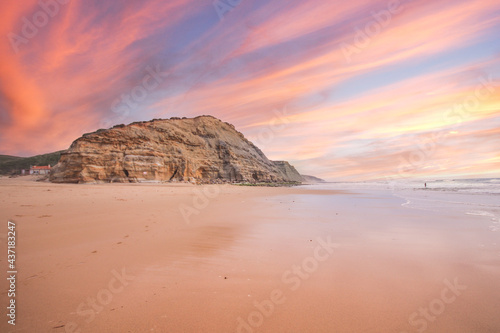 Beautiful sandy ocean beach and cliff at the sunset. Panorama atlantic coastline. © nvphoto