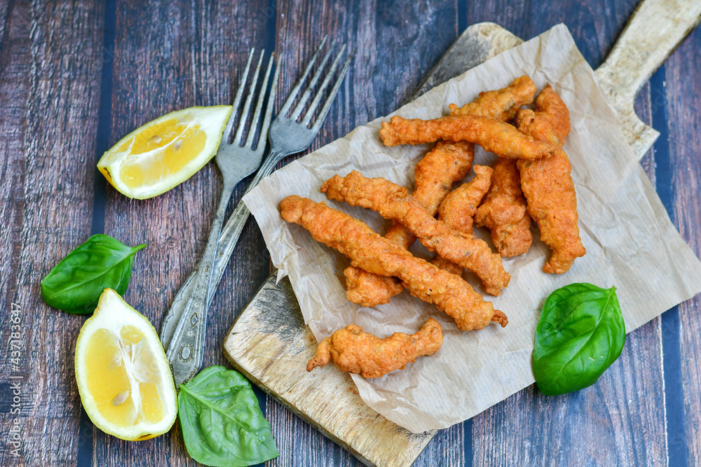 Crispy deep fried home made chicken strips Breaded with almond flour chicken breast fillets with chilly peppers and fresh basil on wooden rustic background. Ketogenic diet food
Crispy deep fried home made chicken strips Breaded with almond flour chicken breast fillets with chilly peppers and fresh basil on wooden rustic background. Ketogenic diet food