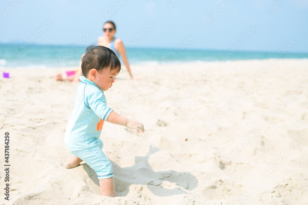 Happy family resting at beach in summer, Mother and baby feet at the sea foam at the sunlight water is moving Happy family resting at beach in summer, Mother and baby feet at the sea foam at the sunlight water is moving