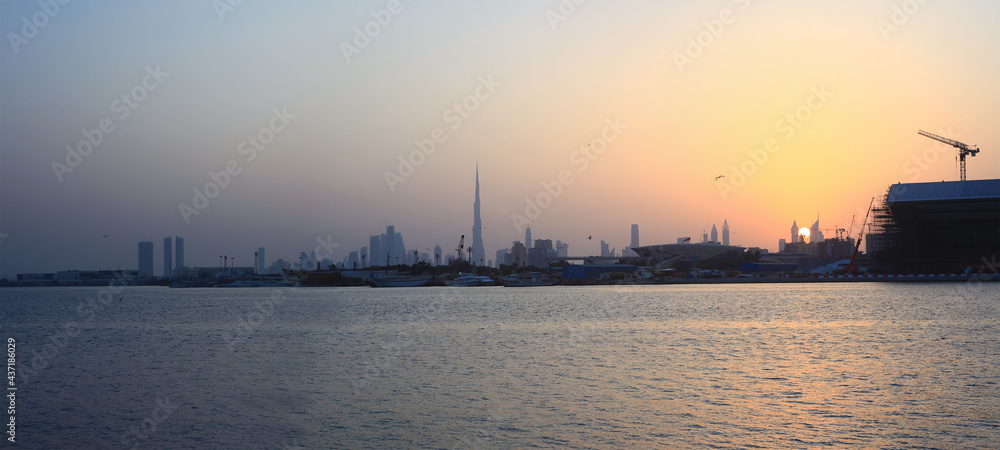 sunset in Dubai city view with birds flying