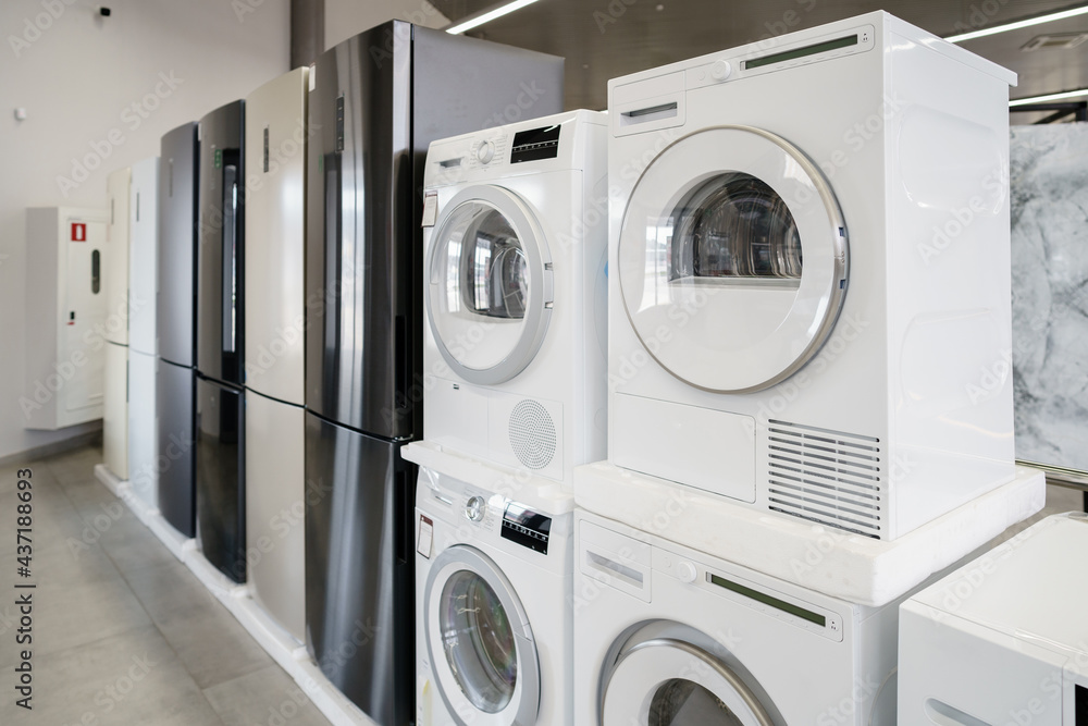 Row of new washing machines in a hypermarket Row of new washing machines in a hypermarket