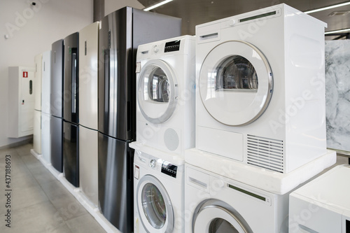 Row of new washing machines in a hypermarket photo