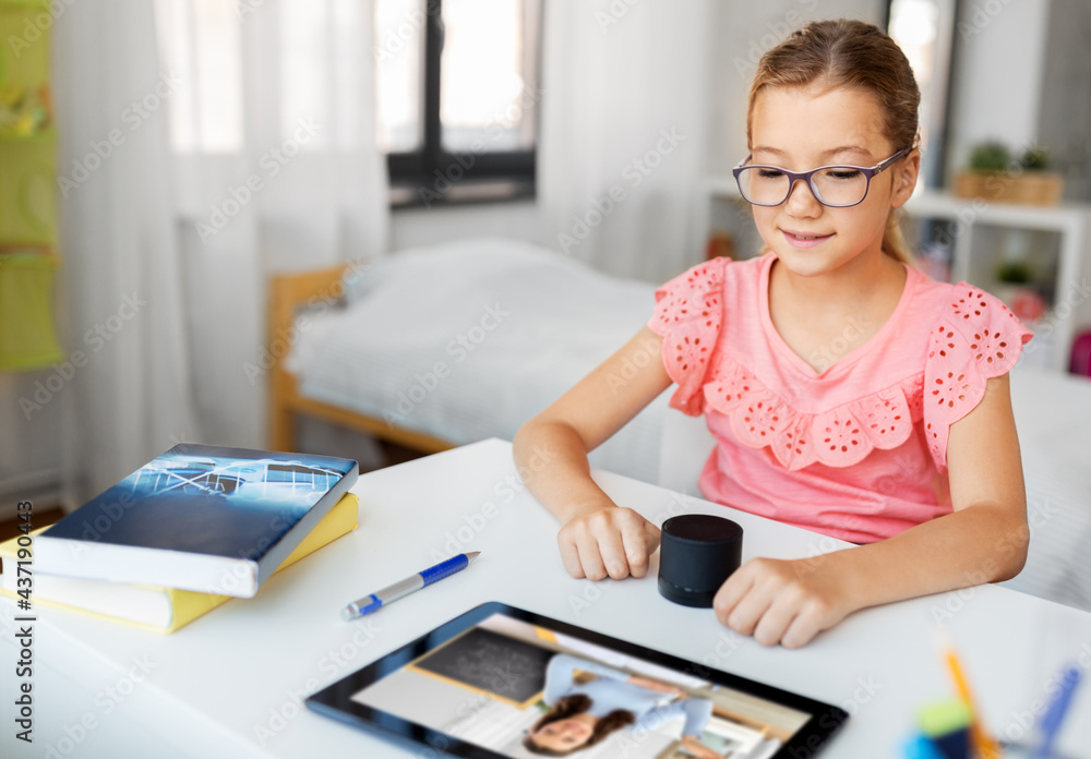 online education, e-learning and technology concept - student girl in glasses with smart speaker and teacher on tablet computer screen having video class at home online education, e-learning and technology concept - student girl in glasses with smart speaker and teacher on tablet computer screen having video class at home