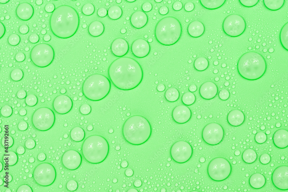 Water drops on green background texture. Backdrop glass covered with drops of water. green bubbles in water.