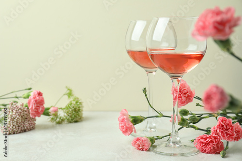 Glasses of pink wine and beautiful flowers