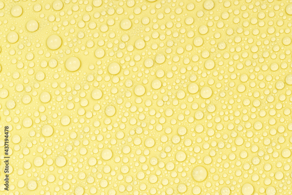Water drops on yellow background texture. Backdrop glass covered with drops of water. yellow bubbles in water. beer texture Water drops on yellow background texture. Backdrop glass covered with drops of water. yellow bubbles in water. beer texture