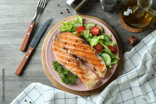 Concept of tasty eating with grilled salmon, top view