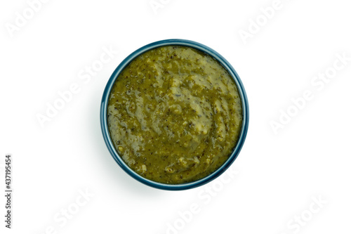 Bowl of Pesto sauce isolated on white background