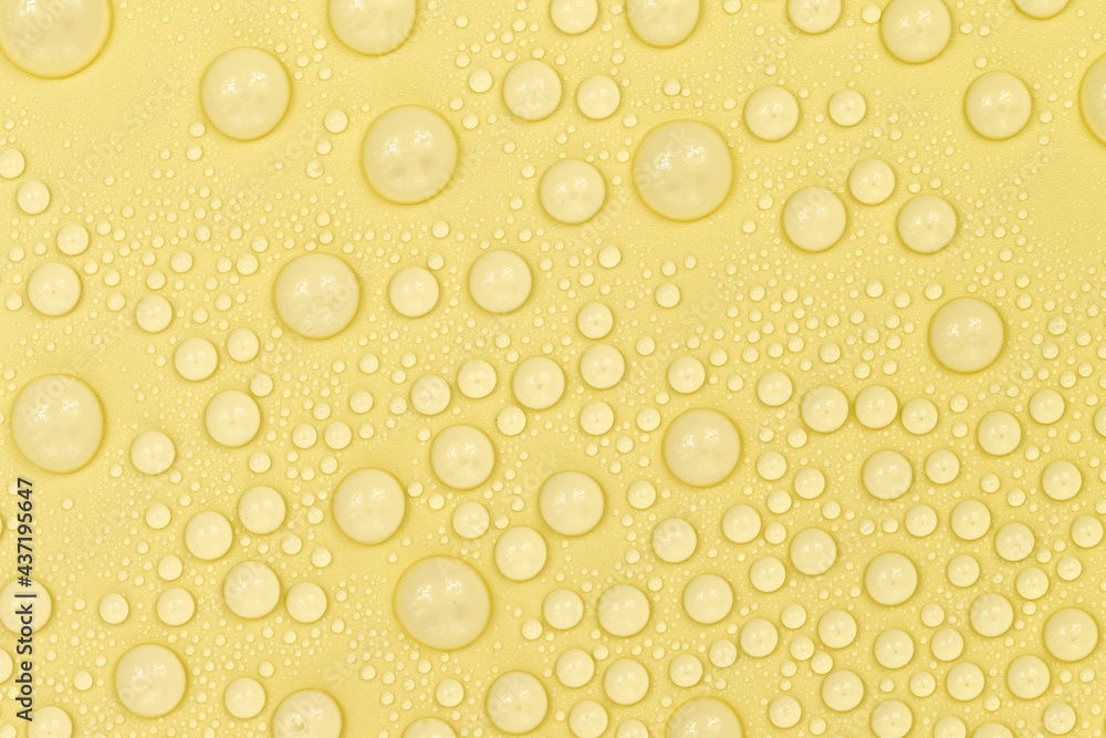 Water drops on yellow background texture. Backdrop glass covered with drops of water. yellow bubbles in water. beer texture Water drops on yellow background texture. Backdrop glass covered with drops of water. yellow bubbles in water. beer texture