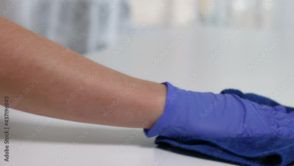 Female person cleaning table with disinfectant spray and microfiber cloth at home. Concept of disinfection and prevention of covid-19. Female person cleaning table with disinfectant spray and microfiber cloth at home. Concept of disinfection and prevention of covid-19.
