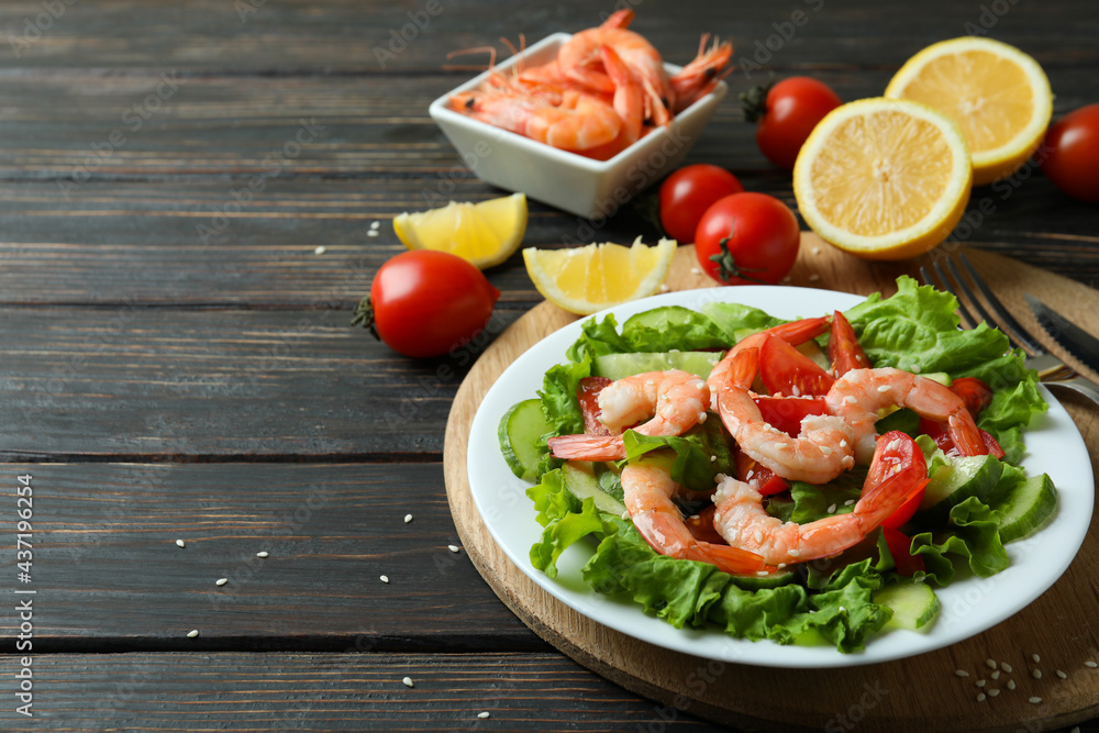 Concept of tasty eating with shrimp salad on wooden table Concept of tasty eating with shrimp salad on wooden table