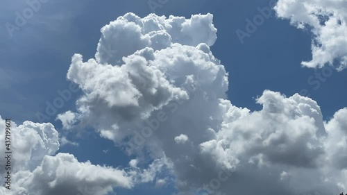 The sky is covered with fluffy cumulus clouds. photo