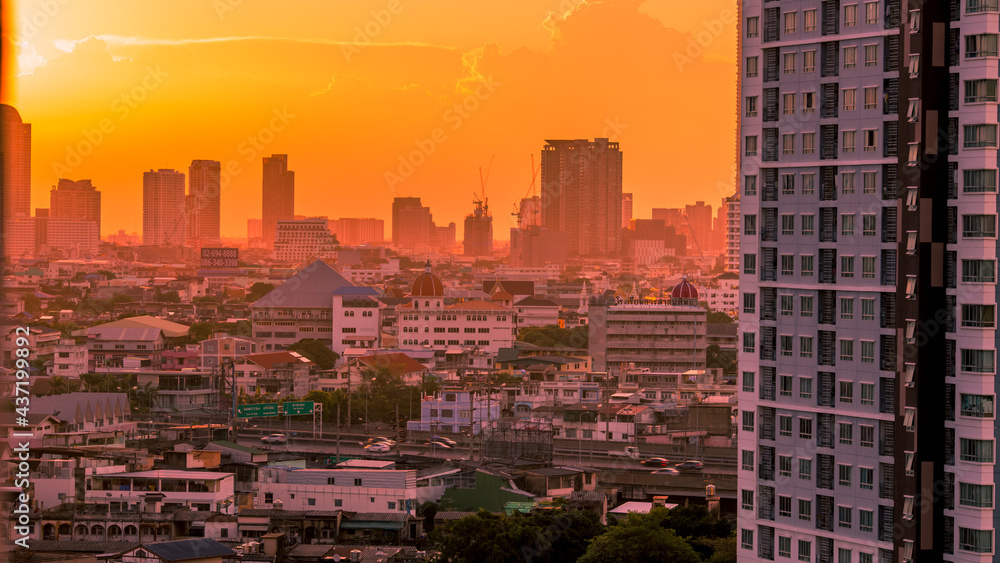 The blurred abstract background of the morning sun exposure to the tiny dust particles that surround the tall buildings in the capital, the long-term health issue of pollution.