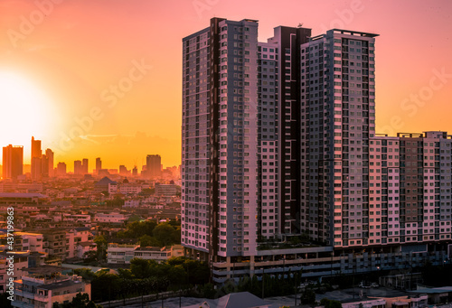 The blurred abstract background of the morning sun exposure to the tiny dust particles that surround the tall buildings in the capital  the long-term health issue of pollution.