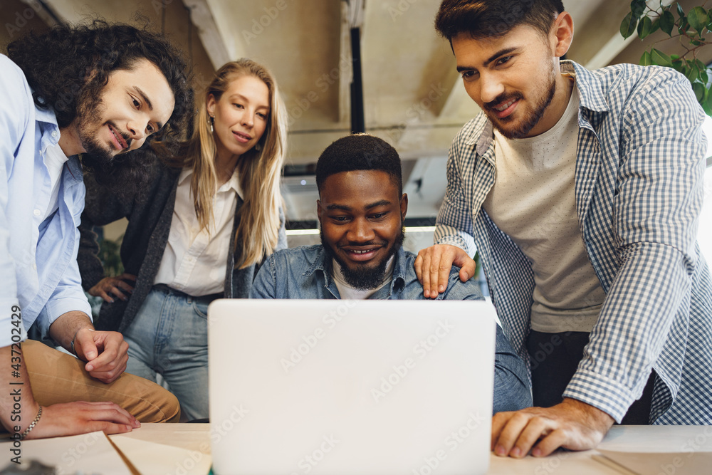 Smiling multiracial coworkers working together at office meeting, have a discussion Smiling multiracial coworkers working together at office meeting, have a discussion