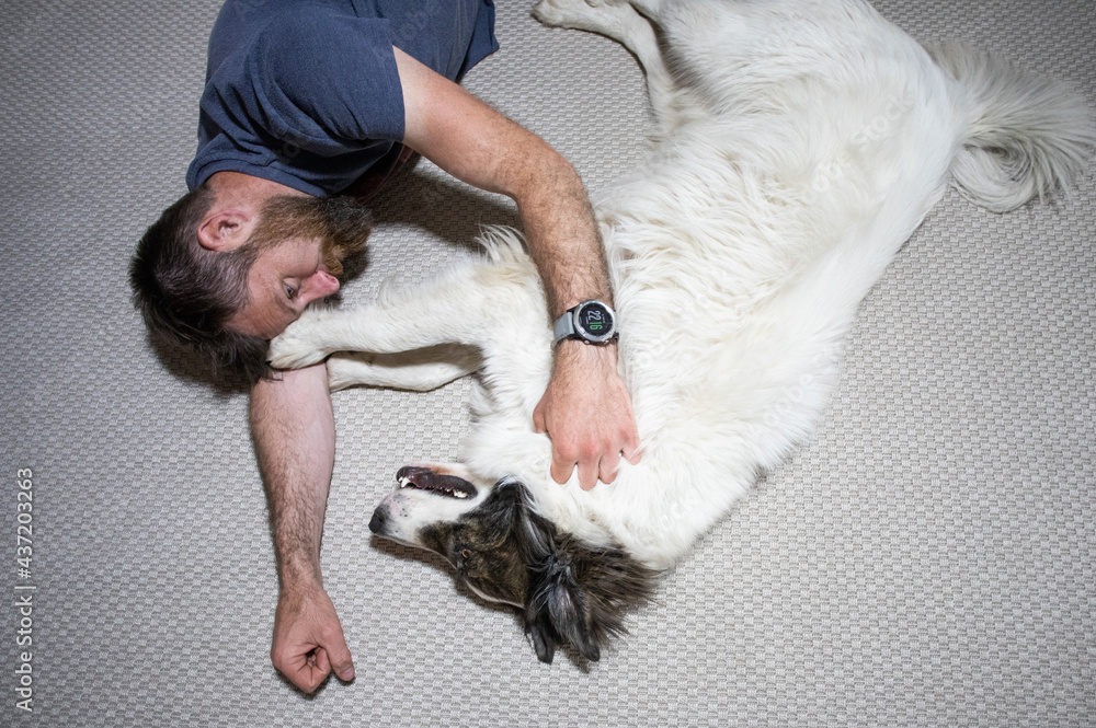 man on the floor hugging his dog man on the floor hugging his dog