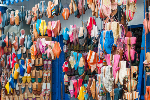 Oriental shoes / Colorful shoes hang in front of a market stall in a souk.
