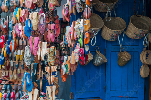 Oriental shoes / Colorful shoes hang in front of a market stall in a souk.