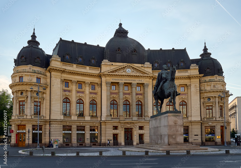 Fototapeta premium Bucharest, Romania, July 14, 2019. Central Library of the University of Bucharest and horse statue of King Charles I 
