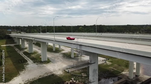 Red Car Crosses The Dupont Bridge In Panama City, Florida. aerial photo