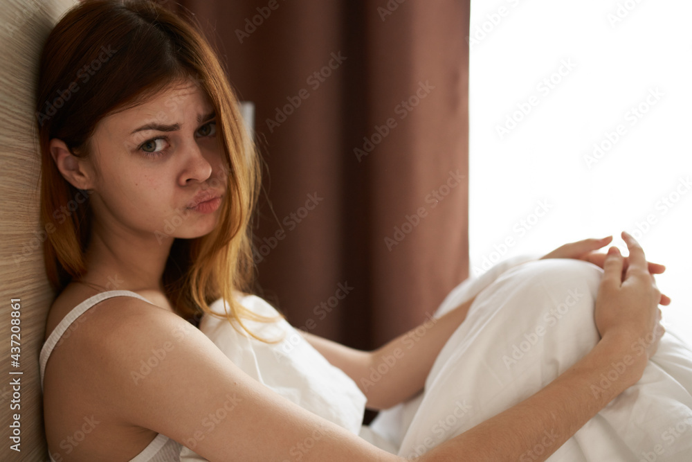 Obraz premium upset woman under blanket bed and open window curtains model side view