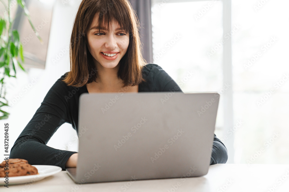 Upset young white woman sitting at the kitchen table Upset young white woman sitting at the kitchen table