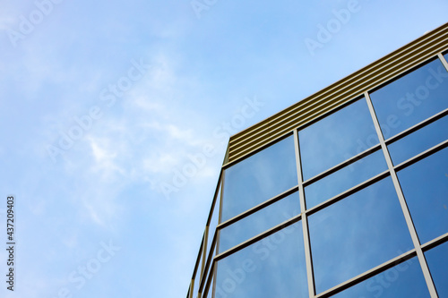 Glass skyscraper against blue sky  view from bottom