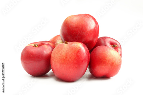 Group of smooth skin nectarines isolated on white background. Delicious fruit