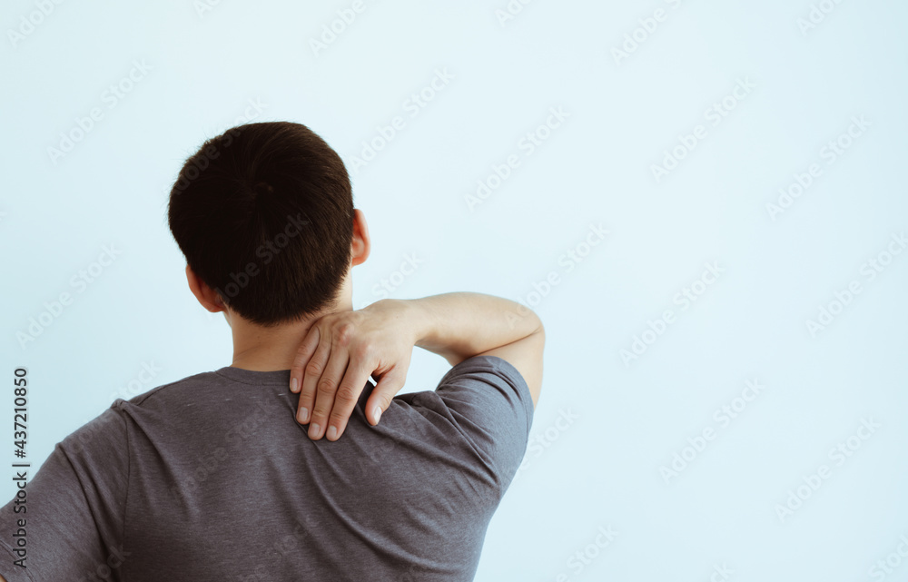 Young man suffering from pain in shoulder Healthcare and health insurance concept Young man suffering from pain in shoulder Healthcare and health insurance concept