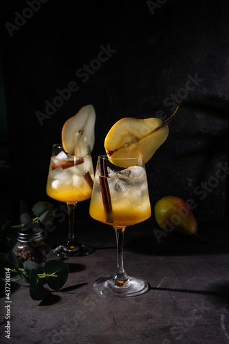 selective focus. bar magazine concept. refreshing cocktail with pear and syrup. low key, dark moord