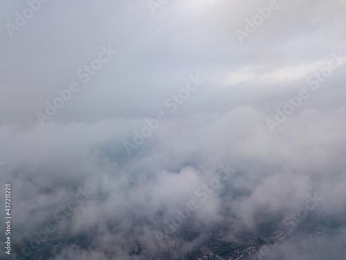 Aerial high flight above the clouds at sunrise.