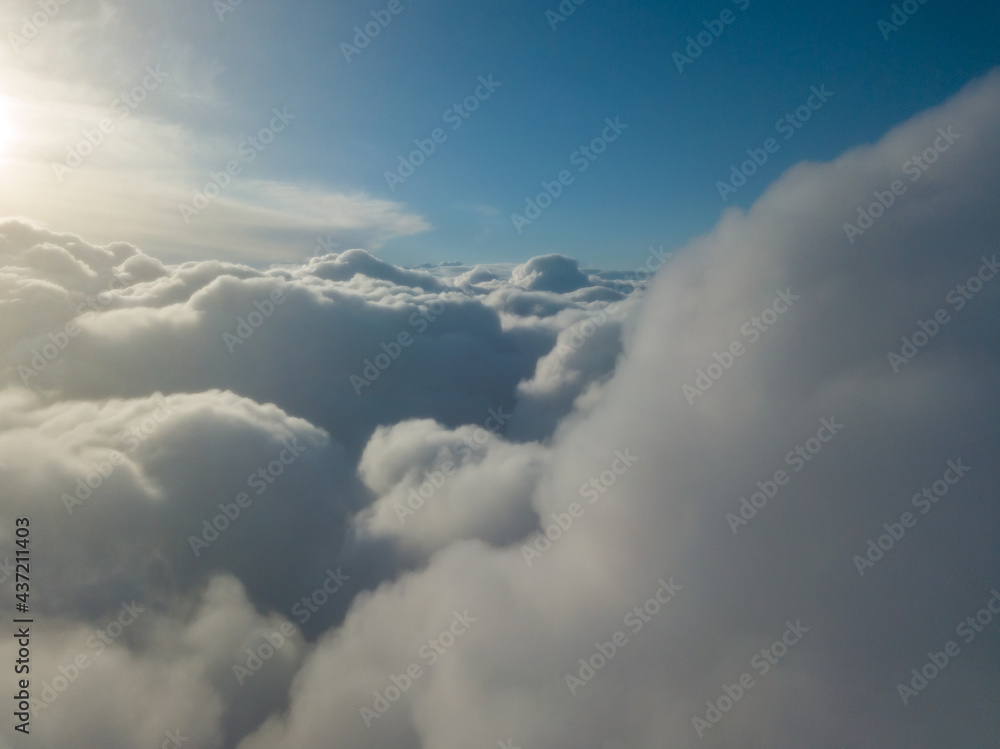 Aerial high flight above the clouds at sunrise. Aerial high flight above the clouds at sunrise.