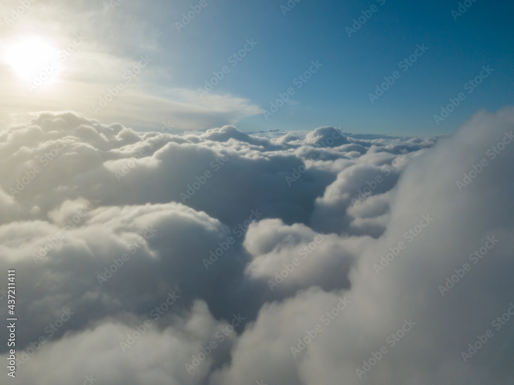 Aerial high flight above the clouds at sunrise. Aerial high flight above the clouds at sunrise.