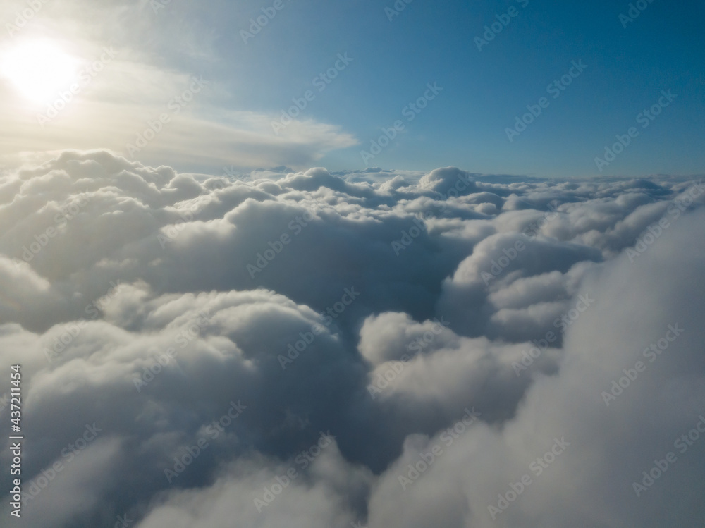 Aerial high flight above the clouds at sunrise. Aerial high flight above the clouds at sunrise.