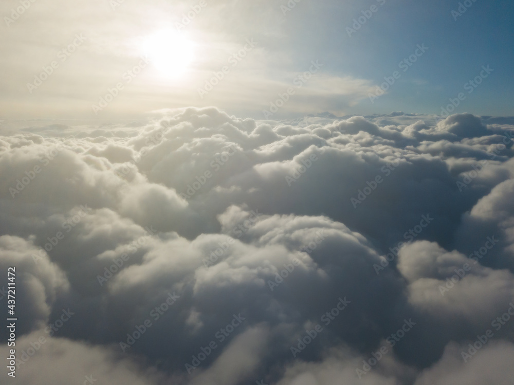 Aerial high flight above the clouds at sunrise. Aerial high flight above the clouds at sunrise.