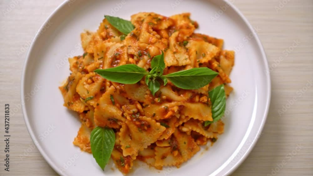 farfalle pasta with basil and garlic in tomato sauce - Italian food style farfalle pasta with basil and garlic in tomato sauce - Italian food style