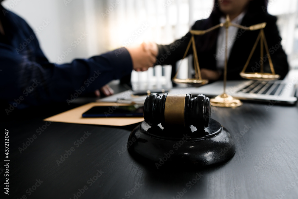 Businessman shaking hands to seal a deal with his partner lawyers or attorneys discussing a contract agreement.Legal law, advice, and justice concept. Businessman shaking hands to seal a deal with his partner lawyers or attorneys discussing a contract agreement.Legal law, advice, and justice concept.