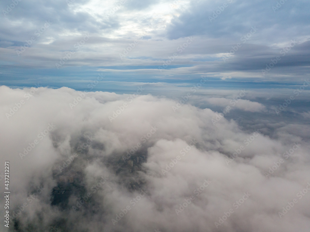Aerial high flight above the clouds. The rays of the rising sun break through the clouds. Aerial high flight above the clouds. The rays of the rising sun break through the clouds.