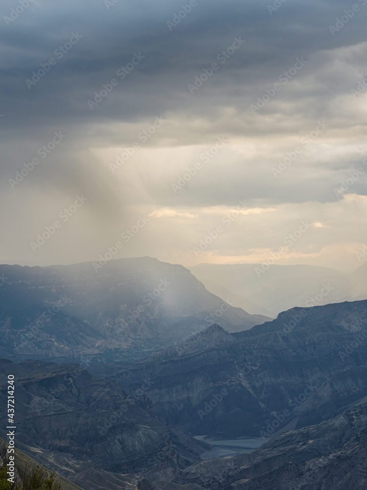 Rainy mountain natural background. Dramatic sky on mountain peaks. Mystical background with dramatic mountains. Rain in mountains.