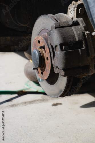 Car service and repair. Tire service. Repair of a broken wheel. Balancing. View of the car on the dock with the wheel removed.