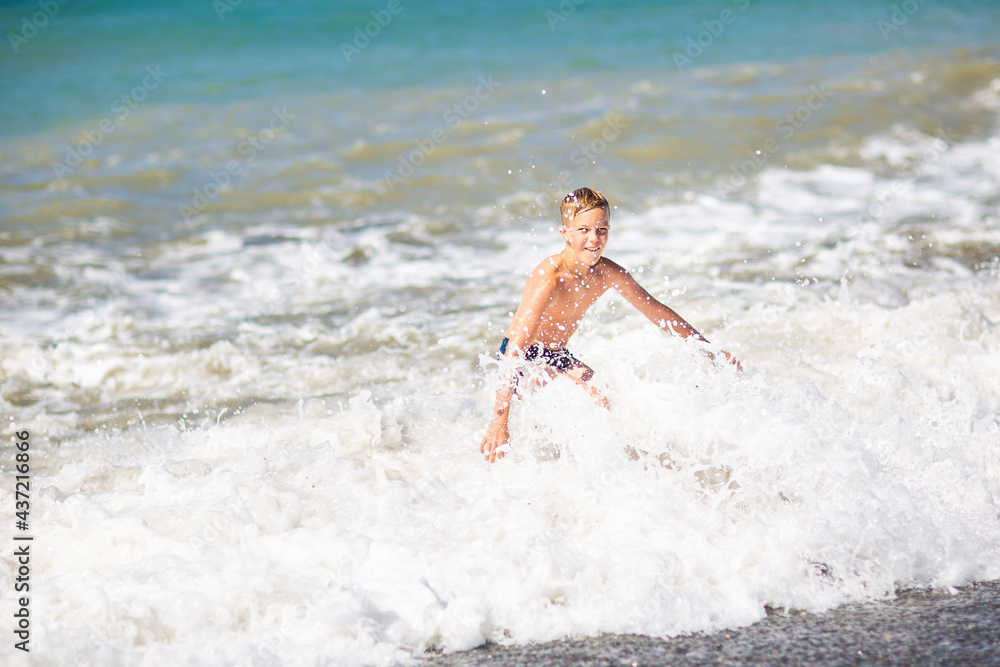 Fototapeta premium boy by the sea in a storm