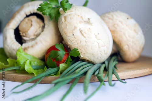 washed vegetables and mushrooms with herbs on a cutting board