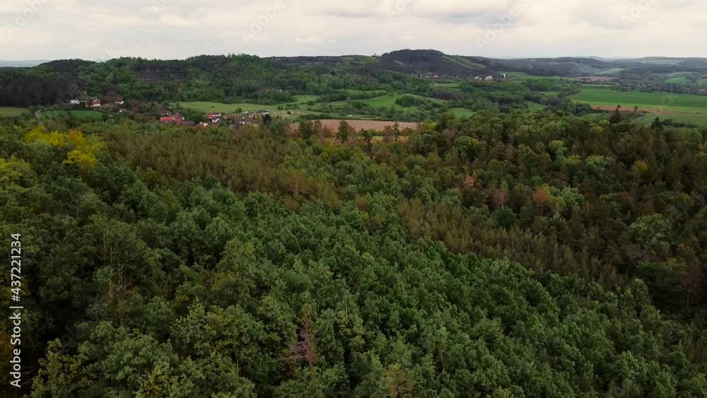 Hilly valley panorama. Picturesque high-mountain village with fields at the foot of green hills. Hilly valley panorama. Picturesque high-mountain village with fields at the foot of green hills.