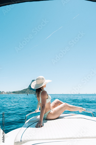 Woman sitting on boat deck at the mediterranean sea