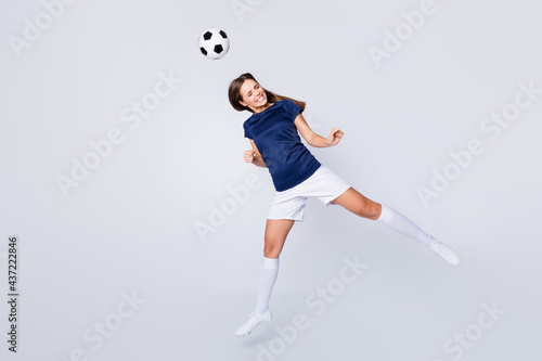 Full length body size view of her she nice attractive lovely motivated sportive addicted straight-haired girl jumping hitting ball having fun hobby isolated on light white gray pastel color background