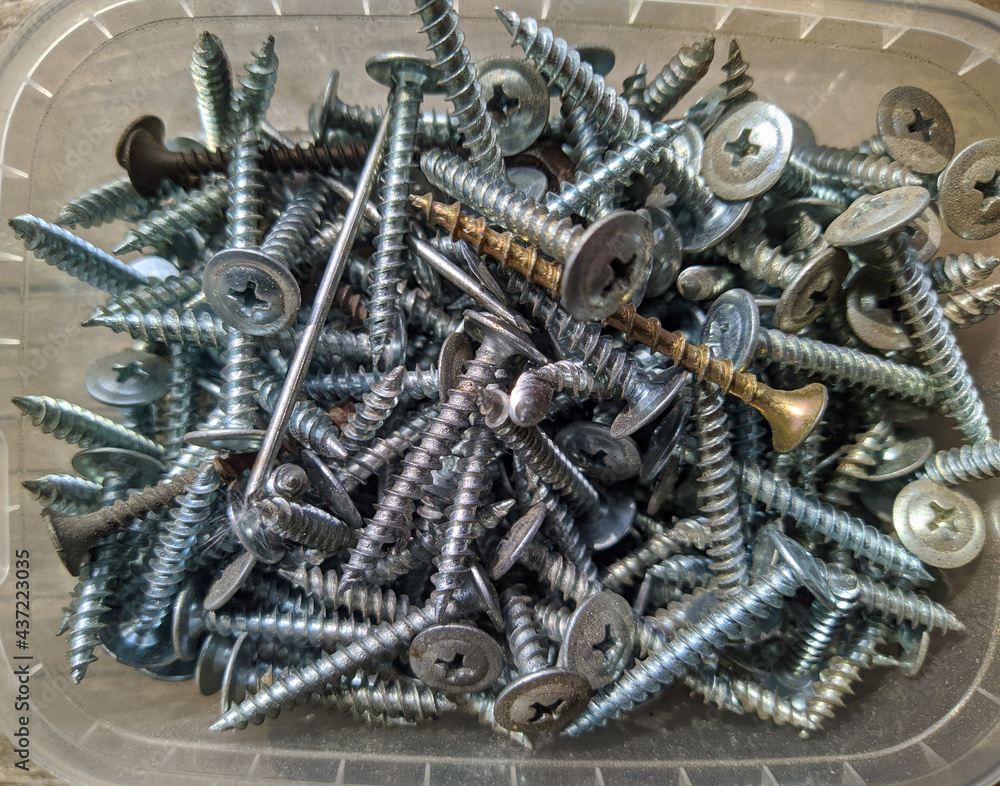 many silver self-tapping screws closeup photo top view many silver self-tapping screws closeup photo top view