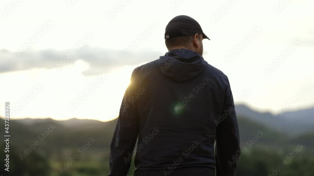 Young man walking to target at sunset with mountain background. Success, happy concept
Young man walking to target at sunset with mountain background. Success, happy concept