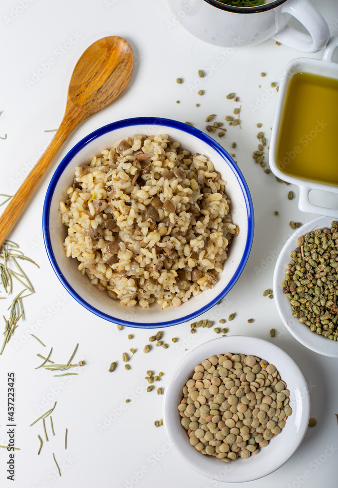 Bulgur pilaf with green lentils with thyme seeds and olive oil on a white background. Bulgur pilaf with green lentils with thyme seeds and olive oil on a white background.