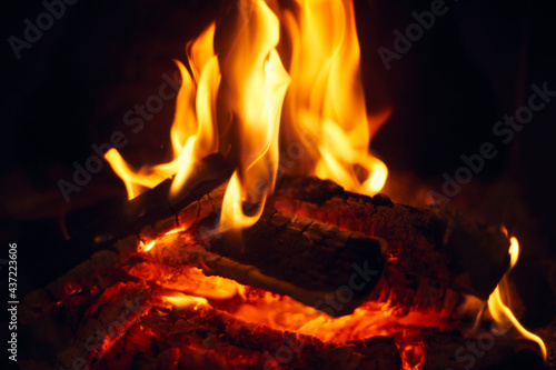 A fire burns in a fireplace  Fire to keep warm. Logs burning in a fireplace